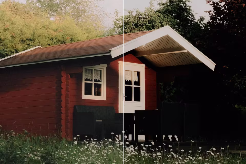A red wooden cabin behind a meadow of daisies, the left half as shot, the right half with the Classic Chrome look