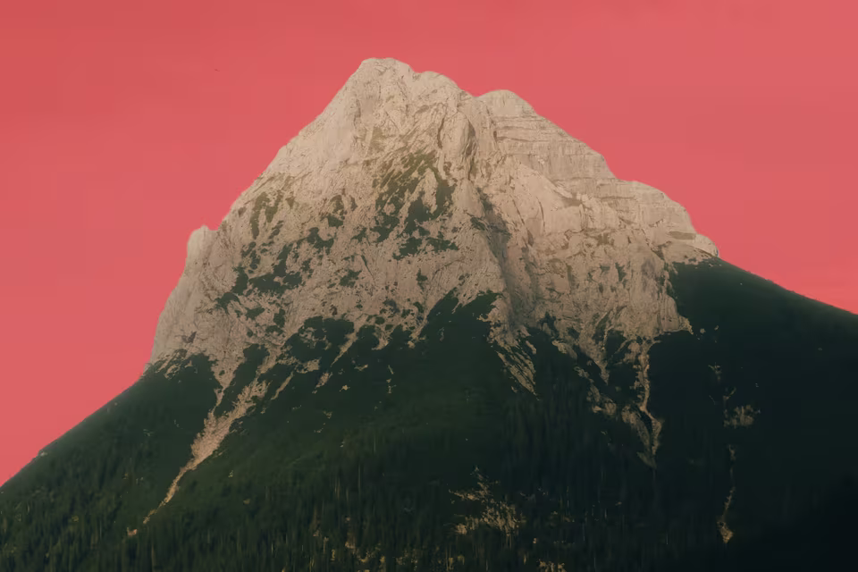 A rocky mountain peak with the sky above it marked in red by a Sky mask