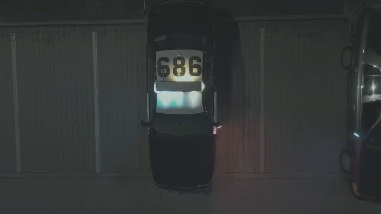 A frame of a night drone clip, flat and gray, the way Log footage looks before it is developed