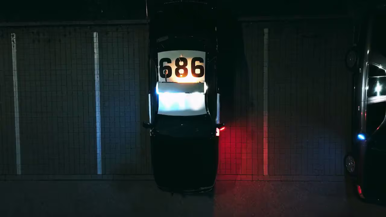 The same frame graded in masoc, with deep blacks and red and blue police lights